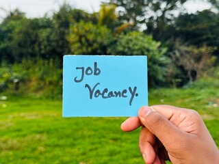 We are hiring trendy card post holding by hand, Join our team recruiting message, Drop your CV sticky note message, Vacancy here image