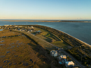 Aerial vew of Caswell Beach on Oak Island NC with Bald Head Island in the distance