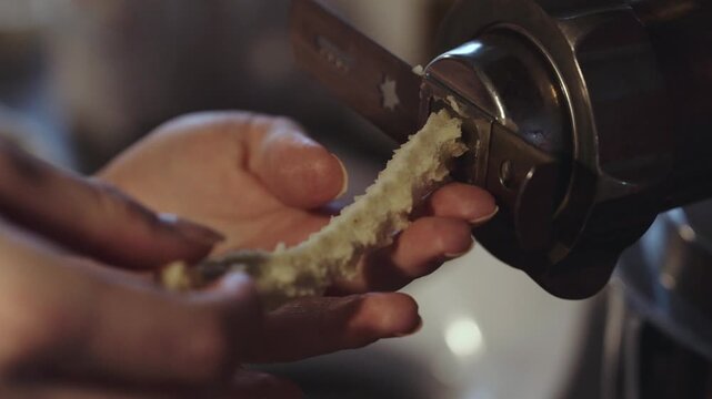 Female hands making dough for traditional Scandinavian Danish Christmas cookies called Vanilla rings, dough getting pushed out for kitchen machine. desaturated footage easily color matched