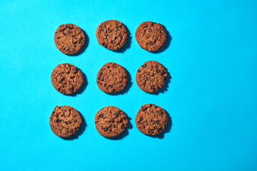 Cookies Arranged on a Blue Surface With Chocolate Chips Visible