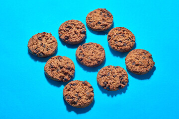 Cookies Arranged on a Blue Surface With Chocolate Chips Visible
