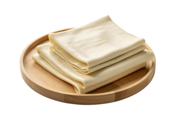 Fresh tofu skin neatly arranged on a wooden plate, ready for preparation . Isolated on transparent background, png