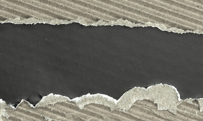 Torn paper background with rough ripped edges and dark center copy space.