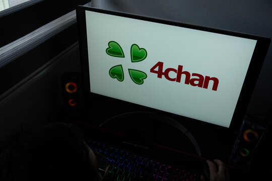 Punta Arenas, Chile &ndash; December 21, 2025: The 4chan logo featuring a four-leaf clover is displayed on a computer monitor in a dark room
