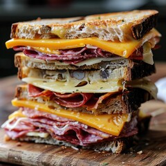 A sandwich with toasted meat and golden brown cheese, with melted cheese dripping from the sides with traces of grilling and a crispy crust.