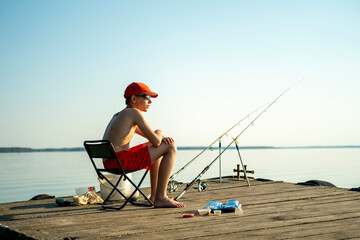 Young Boy Fishing on Dock in Summer