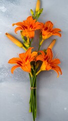 Orange lilies on a light gray surface