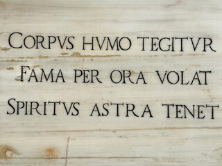 Latin inscription on marble epitaph about life and legacy
