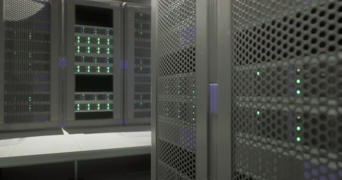Rows of server racks with green lights illuminate the interior of a modern data center. The design emphasizes security and advanced technology while creating an organized space for data management.