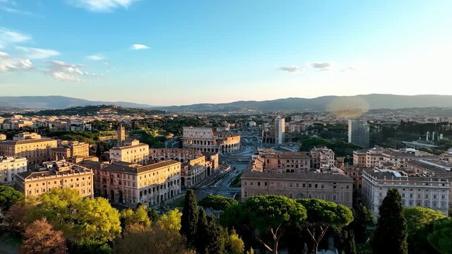 Panoramic aerial view of ancient Roman cityscape with Colosseum and blooming trees at sunset