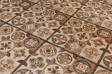 Obraz premium Ceramic tiles with colorful patterns fill the floor of a building. Each tile shows different designs that create a unique visual effect in the space