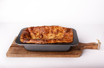 Cottage cheese casserole in a cast iron skillet, side view, space for text.