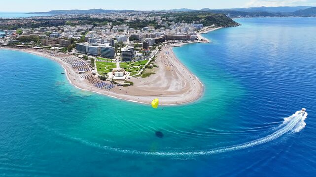 Aerial drone cinematic video of iconic sandy peninsula in main town of Rhodes island with luxury hotels. seaside restaurants and landmark Aquarium, an amazing tourist attraction, Dodecanese, Greece