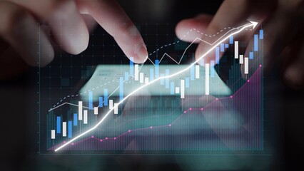 Hands interact with digital charts, highlighting financial growth and market trends. The image represents data analysis in a modern business setting and encourages insights. Copula