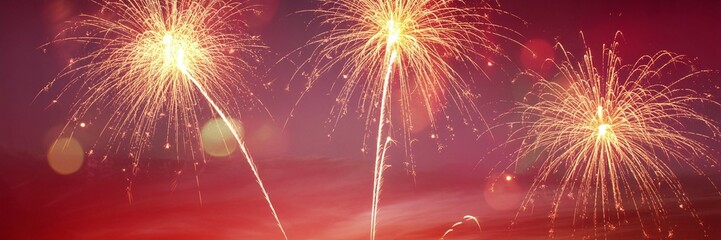 Obraz premium Vibrant Red Fireworks Display with Golden Bursts and Soft Bokeh for Chinese New Year Celebrations Wedding Events and Festive Gala Marketing