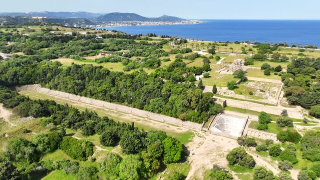 Aerial drone cinematic video of archaeological site of Acropolis, Odeon and Ancient stadium of Rhodes in area of Monte Smith, Rhodes island, Dodecanese, Greece
