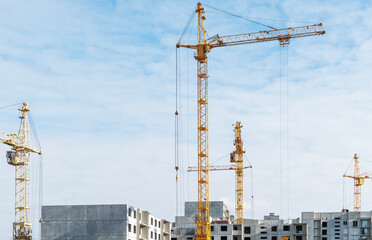 High-rise construction cranes work on construction sites