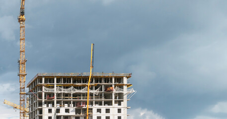 High-rise construction cranes work on construction sites