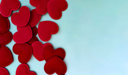 Valentine’s Day background with red fabric hearts and copy space