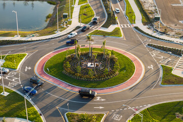 Road roundabout intersection with driving cars. Circular transportation crossroads in Florida. Traffic infrastructure in USA