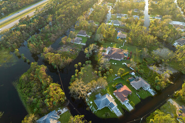 Surrounded by hurricane rainfall flood waters homes in Florida residential area. Aftermath of natural disaster