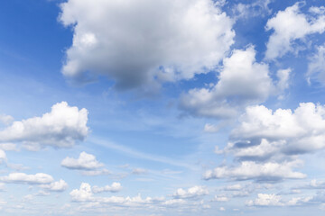 Beautiful light blue sky with many white cirrus and fluffy clouds, background texture, heaven