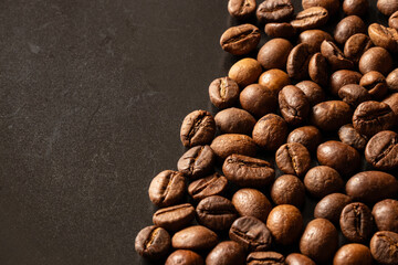 Close-up of roasted coffee beans on a black background, coffee