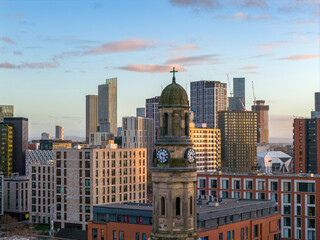 Obraz premium St. Phillips Clocktower set against Manchester's skyscrapers
