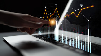 A person interacts with a laptop, showcasing digital graphs and statistics that represent financial growth and business insights, emphasizing modern data analysis techniques. Scalp