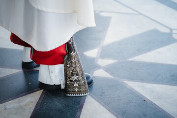 Detailed view of an ornate rifle stock resting near polished boots, hinting at a ceremonial guard presence. Traditional military craftsmanship and quiet authority captured in a close-up moment.