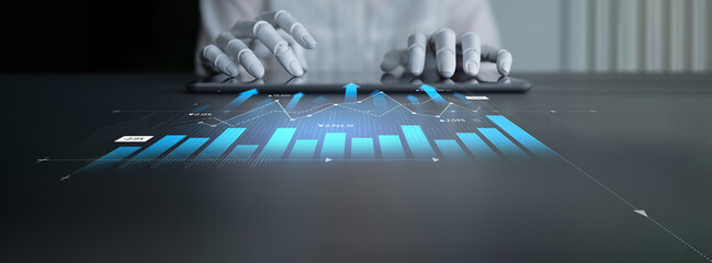 A pair of hands interacts with a digital tablet, showcasing dynamic data visualization and charts, reflecting the integration of technology in business analysis and innovation. Scalp