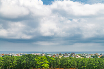Atlantic coastline view with seaside homes and forest foreground in North Carolina