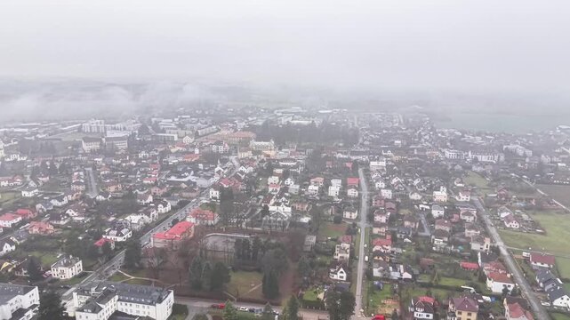 aerial view of coastal suburbs roofs and shoreline overcast conditions real estate agent scouting properties