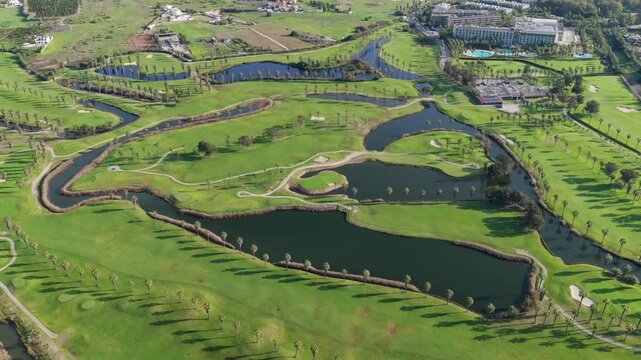 The Ultimate Retirement Dream: Cinematic Aerial Flyover of Salgados Golf Course Nestled Between the Atlantic Ocean and Natural Lagoons in Algarve, Portugal