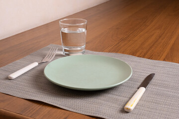 Simple place setting with plate, fork, knife, and water glass