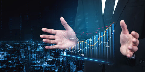 A businessman showcases a digital financial graph with hands spread, symbolizing growth and success metrics against a stunning night cityscape backdrop. Scalp