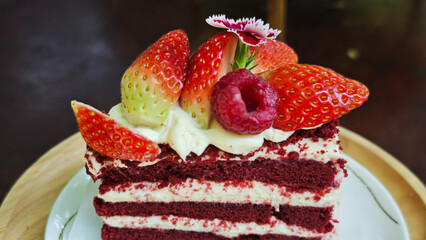 Red Velvet cake topped with fresh strawberries and raspberries.