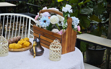 Rustic wooden crate filled with blue, white, and orange artificial flowers 