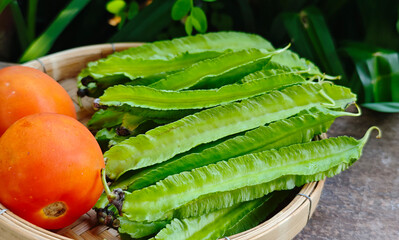 Fresh winged beans in a basket.