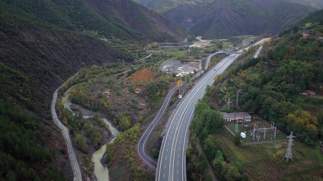 Aerial view of the A1 motorway winding through the colourful autumn mountains of Mirdit&euml; District in northern Albania.