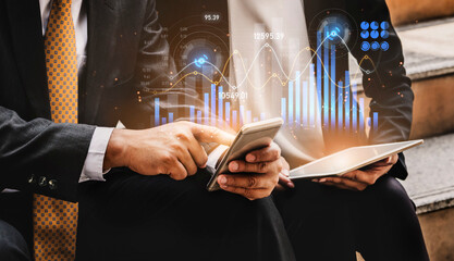 Two business professionals engage in a discussion about financial data, analyzing digital charts...