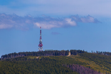 Telecommunication tower on Skrzyczne summit surrounded by forested mountain ridge in Beskid Slaski