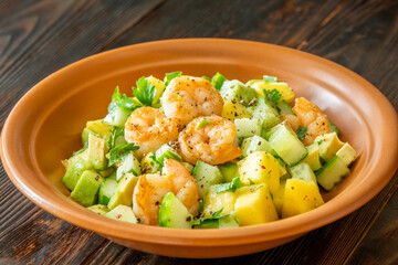 Fresh shrimp salad with mango, avocado, cucumber in lemon olive dressing