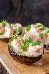 Avocado halves filled with guacamole and shrimp topped with spicy sriracha mayo