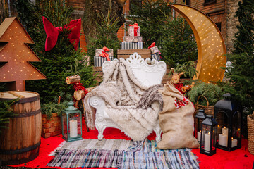 Festive holiday scene featuring a cozy white chair draped with a soft blanket, surrounded by decorated Christmas trees and glowing lights, creating a warm and inviting atmosphere