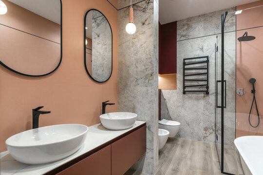 The modern bathroom design is characterized by elegant fixtures and soft colors with a spacious layout.