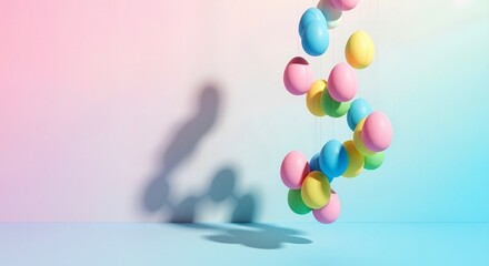 A spiral of colorful pastel Easter eggs hanging as a minimalist decoration. Spring holiday celebration concept on a gradient background with copy space for a banner