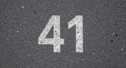 White Number Forty one Painted on Gritty Asphalt Road Surface