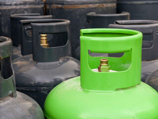 green gas cylinders with valves and weathered paint