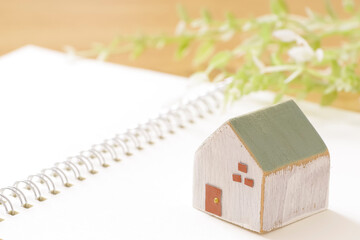 House building notebook and wooden house model